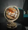 A wooden globe model with internal lighting sits on a dark surface. Náhľad obrázku produktu