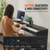 A woman plays a digital piano while a laptop and tablet are connected to it. Produktbild-Vorschau