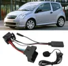A silver car is shown in the upper part of the image, and a car stereo adapter with cables and a microphone is shown in the lower part. Náhľad obrázku produktu