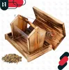 A wooden bird feeder with clear acrylic sides, shown with a pile of birdseed next to it. The feeder is open, revealing its interior. Produktbild-Vorschau