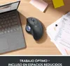 A Logitech trackball mouse is shown on a wooden desk next to a laptop and some papers. Anteprima dell’immagine prodotto
