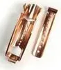 Two copper-colored metal objects, possibly fireplace tongs, are shown against a white background. Produktbild-Vorschau