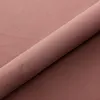 A rolled-up piece of pink fabric, likely upholstery or bedding, with a subtle sheen and texture. Produktbild-Vorschau