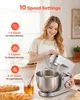 A woman is using a stand mixer in a kitchen setting, with baked goods and honey in the foreground. Produktbild-Vorschau