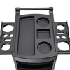 A close-up, top-down view of a black salon trolley with various compartments and cup holders. Voir les images du produit