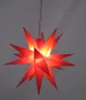 A red star-shaped lantern hangs from a wire against a gray background. Produktbild-Vorschau