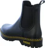 A black Chelsea boot with a thick sole and yellow stitching. Produktbild-Vorschau