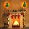 A festive Christmas fireplace scene with stockings hung and decorated with lights and garlands. Náhľad obrázku produktu
