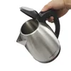 A hand is holding a stainless steel electric kettle with the lid open. Náhled obrázku produktu