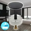 A bathroom drain stopper is shown in the foreground, with a blurred bathroom scene in the background. Produktbild-Vorschau