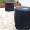 Two round tables covered with black protective covers are placed on a light-colored tiled patio. Anteprima dell’immagine prodotto