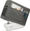 A grey sewing machine cover is placed over a white sewing machine. The cover has several pockets which contain items such as a magazine, a ruler, and some fabric. Produktbild-Vorschau