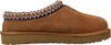 A side view of a brown UGG slipper with a decorative trim around the opening. Anteprima dell’immagine prodotto
