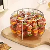 A metal skewer rack filled with raw meat and vegetable skewers, placed on a wooden cutting board. Náhľad obrázku produktu