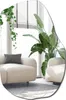 A living room scene with two beige sofas, a large potted plant, and a hanging plant near a window with blinds. Produktbild-Vorschau