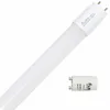 A white LED tube light with a white base and two metal pins is shown diagonally against a white background. A smaller cylindrical component with text and a logo is placed to the right of the main product. Produktbild-Vorschau