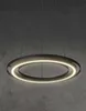 A modern, circular pendant light with integrated LED lighting, suspended against a textured gray concrete wall. Produktbild-Vorschau