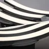 Close-up view of a modern black ceiling lamp with curved LED light strips. Anteprima dell’immagine prodotto