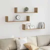 Three wooden shelves mounted on a white wall above a sofa, decorated with books, a clock, and picture frames. Anteprima dell’immagine prodotto