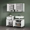 A bathroom vanity set with cabinets and a sink against a green wall. Produktbild-Vorschau