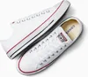 A pair of white Converse All Star low-top sneakers. Voir les images du produit