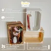 Three wooden crates are displayed, one with a vase and flowers, another with a book, and a third empty crate. Text overlays describe features and dimensions. Produktbild-Vorschau