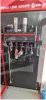 A display stand with tools and lights, likely in a retail or workshop setting. Produktbild-Vorschau