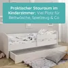 A white children's bed with a pull-out drawer, set up in a bedroom. Produktbild-Vorschau