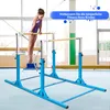 A young girl is practicing gymnastics on parallel bars in a gym. Anteprima dell’immagine prodotto
