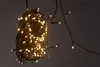 A close-up shot of a tangled ball of LED string lights with a few strands extending out. Produktbild-Vorschau
