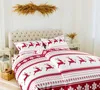 A Christmas-themed duvet cover and pillowcases with a reindeer pattern are displayed on a bed. Podgląd zdjęcia produktu