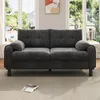 A gray sofa is placed in a well-lit room with large windows in the background. Produktbild-Vorschau
