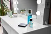 A white vanity table with makeup and skincare products, and a mirror with LED lights. Produktbild-Vorschau