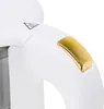 A close-up of a white and gold electric kettle's handle and a warning symbol. Produktbild-Vorschau
