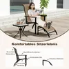 A woman relaxing on a chaise lounge on a wooden deck next to a small table. Anteprima dell’immagine prodotto