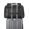 A black duffel bag is placed on top of a gray suitcase, with the suitcase's telescopic handle extended. Produktbild-Vorschau