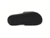 The sole of a black slide sandal is shown against a white background. Podgląd zdjęcia produktu