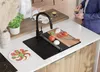 A kitchen scene with a sink, cutting board, and food preparation. Produktbild-Vorschau