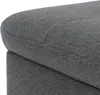 A close-up shot of the textured fabric of a gray ottoman. Náhľad obrázku produktu