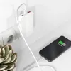 A white power adapter is plugged into a wall socket, charging a smartphone on a desk. Podgląd zdjęcia produktu
