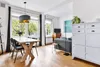 A dining area and living room space with a table, chairs, sofa, and cabinet. Anteprima dell’immagine prodotto