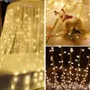 A collage of three images showing different arrangements of warm white LED string lights, one draped over a bed canopy, another decorating a wooden structure with festive ornaments, and the third showing a close-up of the lights against a dark background. Anteprima dell’immagine prodotto