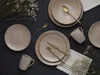 A table setting with plates, mugs, and cutlery, decorated with dried flowers. Produktbild-Vorschau