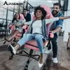People enjoying themselves while riding in gaming chairs. Produktbild-Vorschau
