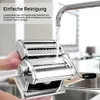 A pasta maker being cleaned under running water. Produktbild-Vorschau
