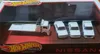 A Hot Wheels Premium collector set featuring a white tow truck and three white Nissan Skyline cars, displayed in a clear plastic packaging. Anteprima dell’immagine prodotto
