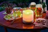 A table set for an outdoor gathering with snacks, drinks, and a decorative candle. Produktbild-Vorschau