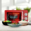 A red retro-style microwave oven is shown with several bowls of food in front of it. Anteprima dell’immagine prodotto