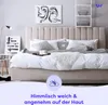A bedroom scene with a bed, pillows, and artwork. Produktbild-Vorschau