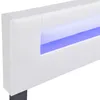 Close-up of a white upholstered bed frame with integrated blue LED lighting. Náhled obrázku produktu
